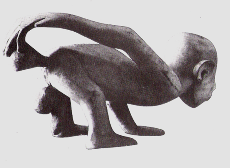 African wood carving demonstrating a pressure enema using an animal bladder. 19th Century.