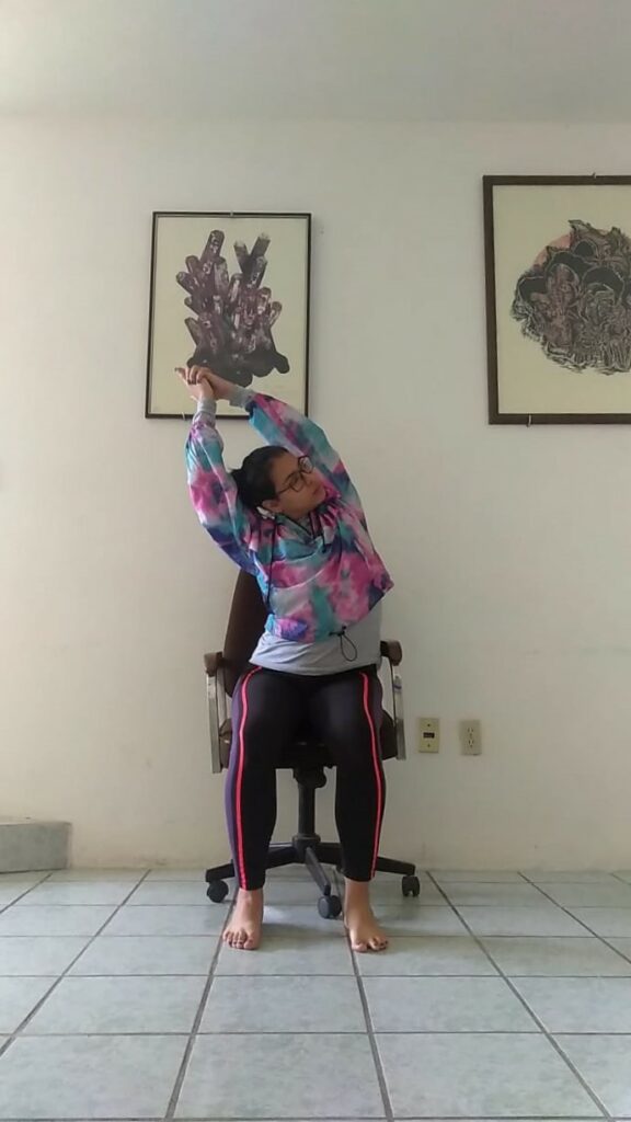 Woman doing yoga stretch on chair