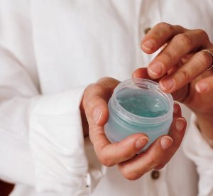 Woman applying a gel on her hands