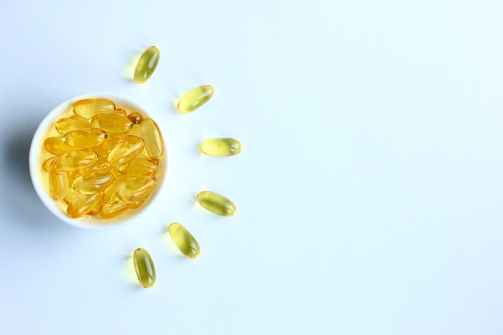 omega 3 pills in a cup on a table