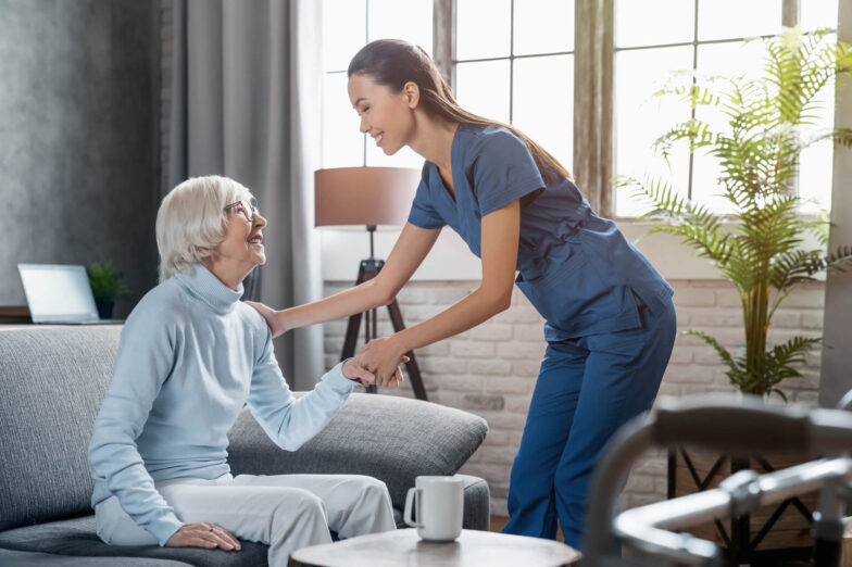Happy female professional caregiver taking care